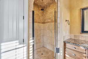 Bathroom with a stall shower and vanity