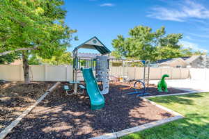 View of playground featuring a fenced backyard