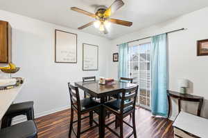 Dining space with baseboards and dark wood finished floors