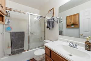 Bathroom featuring vanity and enclosed tub / shower combo