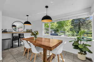 Dining space with light tile patterned floors