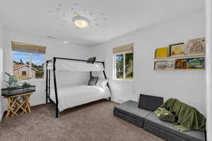 Bedroom featuring carpet floors and baseboards