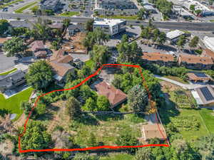 Aerial perspective of suburban area featuring property boundaries highlighted
