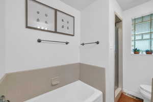 Full bathroom featuring a garden tub and a stall shower