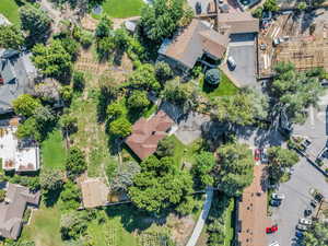 Aerial view of property and surrounding area featuring nearby suburban area
