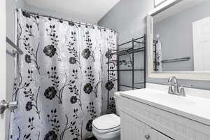Bathroom with vanity and a shower with shower curtain