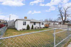 View of front of home featuring a fenced backyard and a chimney