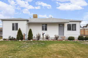 View of front facade featuring a chimney