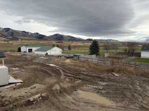 View of mountain backdrop with rural landscape