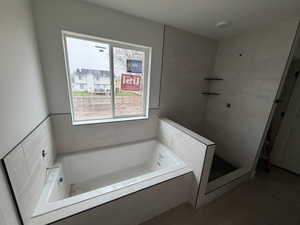 Bathroom with a garden tub and a shower stall