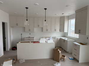 Kitchen featuring a kitchen island and hanging light fixtures
