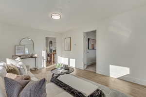 Living area with wood finished floors and baseboards