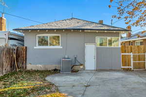 Back of house featuring stucco siding, a patio, and a chimney