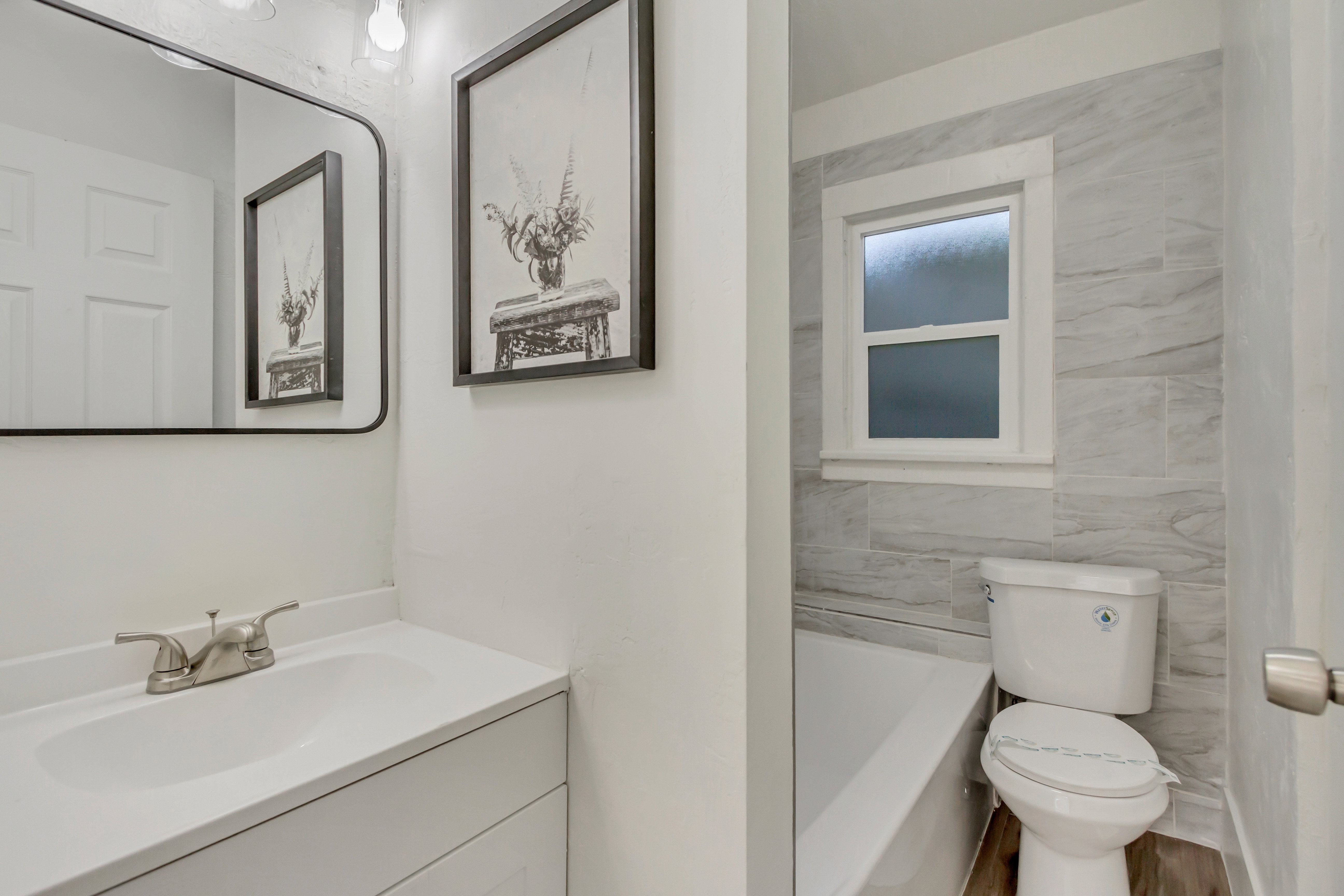 Full bath with vanity and tile walls