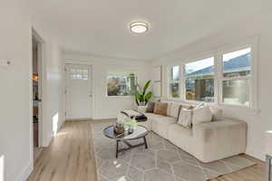 Living area with light wood-type flooring and baseboards