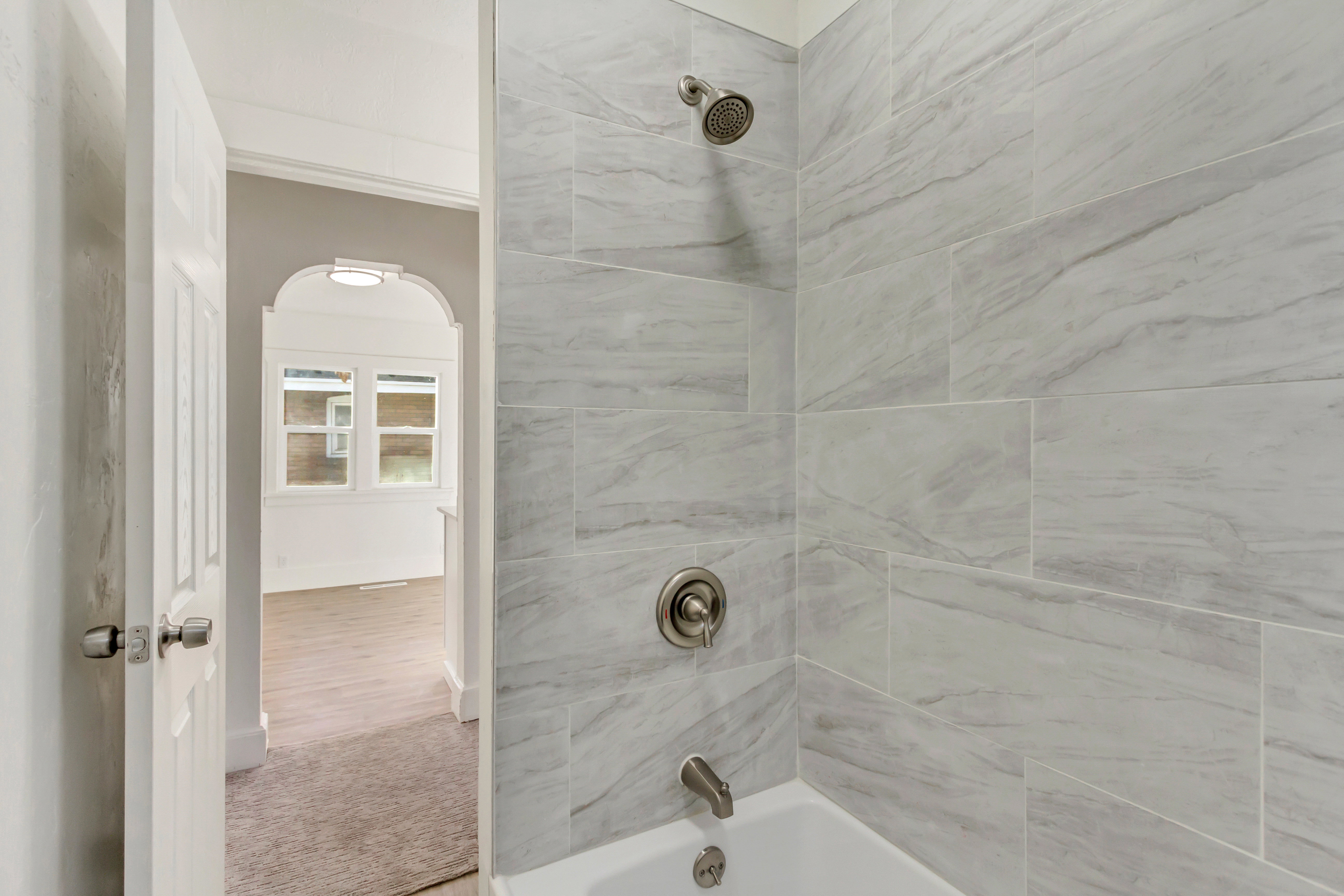 Bathroom with shower / bath combination and light carpet