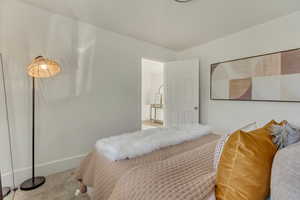 Carpeted bedroom with baseboards