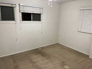 Carpeted spare room with baseboards and a textured ceiling