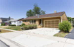 View of front of property featuring driveway and an attached garage