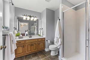 Bathroom with vanity and a shower stall