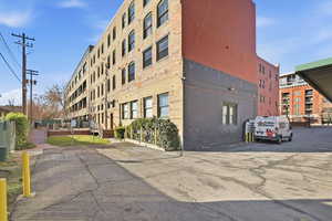 View of apartment building / complex featuring uncovered parking