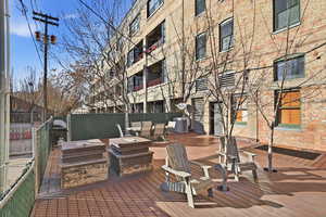 Wooden deck with outdoor dining area and a grill