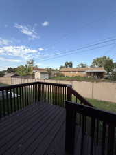 Wooden deck featuring a fenced backyard and an outdoor structure