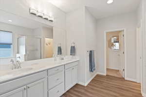 Spacious primary suite with walk-in closet, double vanity, soaking tub, and separate shower
