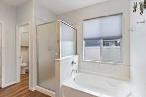 Spacious primary suite with walk-in closet, double vanity, soaking tub, and separate shower
