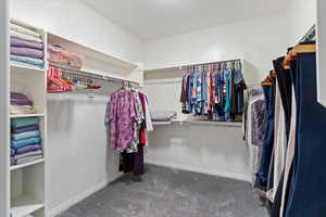 Spacious primary suite with walk-in closet, double vanity, soaking tub, and separate shower