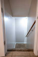 Staircase with tile patterned floors
