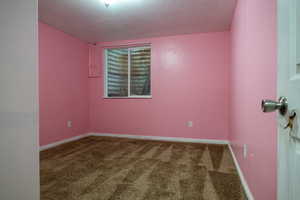 Carpeted empty room with baseboards