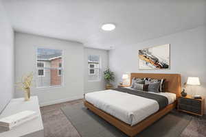 Carpeted bedroom featuring baseboards and a textured ceiling