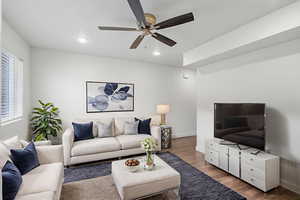 Living room featuring wood finished floors, ceiling fan, and recessed lighting