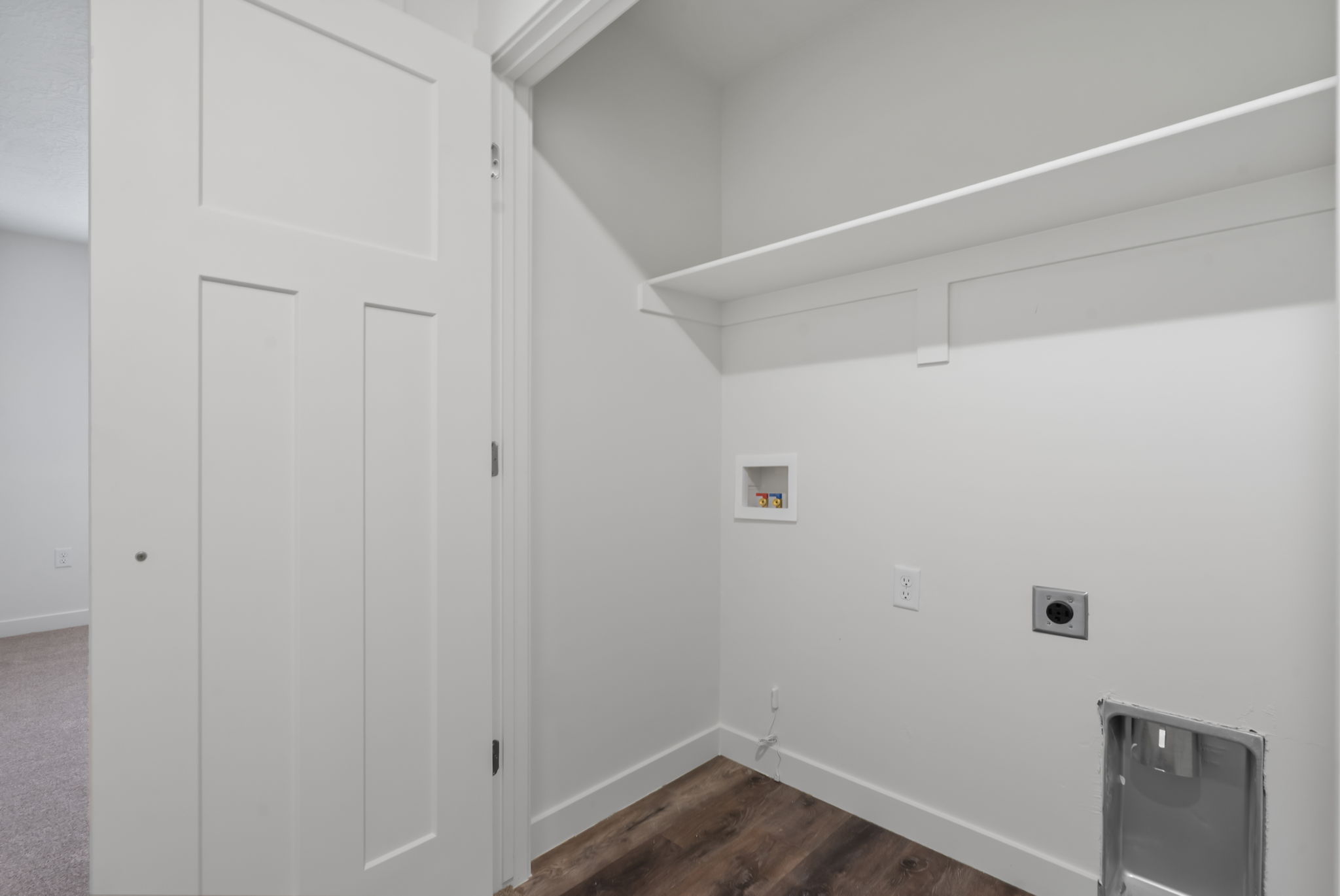 Washroom with washer hookup, hookup for an electric dryer, and dark wood-style floors