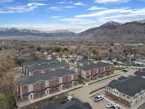 Aerial view of property's location with a mountain backdrop and nearby suburban area