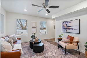 Living area featuring wood finished floors, recessed lighting, and a ceiling fan