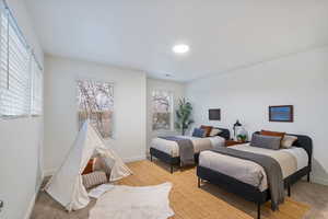 Carpeted bedroom featuring baseboards