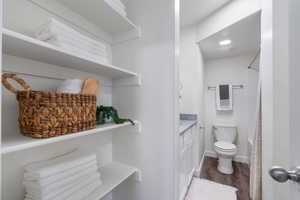 Primary bathroom with vanity, dark wood-style flooring, and shower / tub combo with curtain