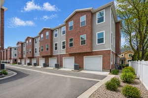 View of property with an attached garage and driveway