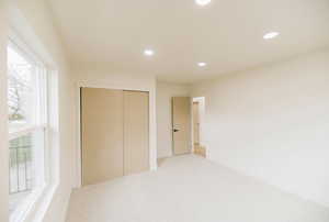 Unfurnished bedroom with a closet, recessed lighting, and carpet flooring