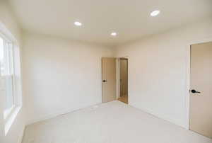 Unfurnished bedroom featuring carpet flooring and recessed lighting