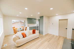 Living room featuring recessed lighting and light wood-type flooring