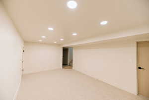 Finished basement with recessed lighting, carpet floors, and stairs