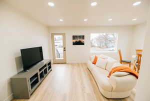 Living area with recessed lighting and light wood-type flooring