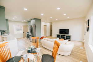 Living area with recessed lighting and light wood finished floors