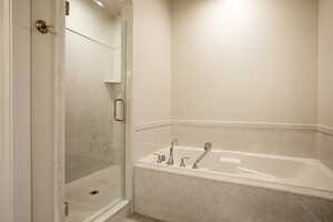 Full bath with a garden tub and a stall shower