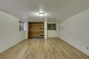 Spare room with a textured ceiling and light wood-style floors