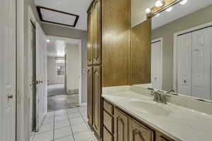 Bathroom with a closet and vanity