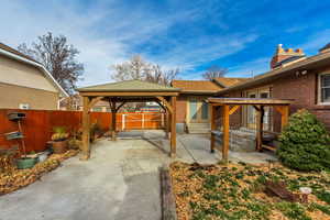 View of patio with a gazebo and entry steps